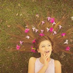 Girl with flowwers laying in the grass