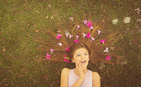 Girl with flowwers laying in the grass